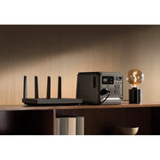 DJI Power 1000 Mini on wooden shelf with router